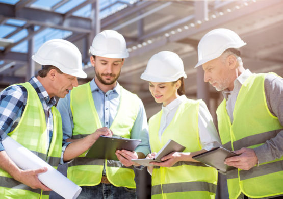 Architects engineer discussing at the table with blueprint - Closeup on hands and project print, Team group on construciton site check documents and business workflow